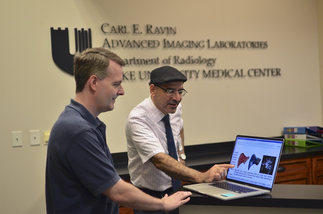 Dr. Samei and Paul Segars Ph.D. looking at research at Carl Ravin Advanced Imaging Laboratories