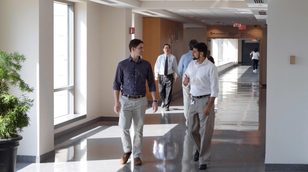 The Medical Physics graduate program faculty members are walking in the hallway at Duke