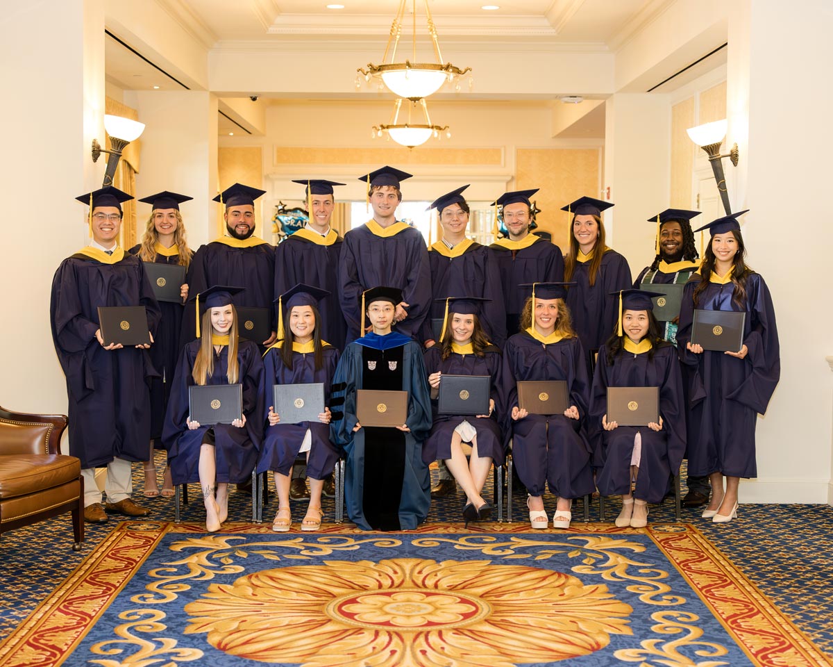 Class of 2024 Group Photo, holding diplomas and wearing graduation gowns